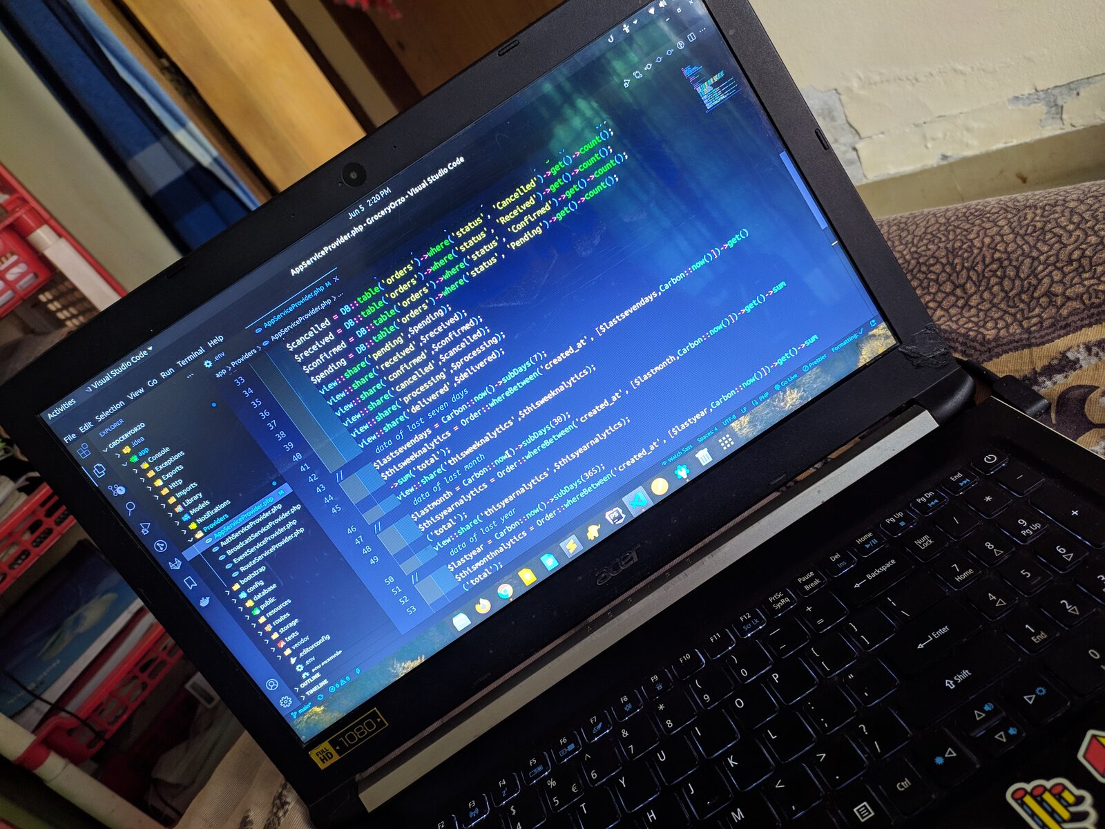 A laptop displaying the macOS Big Sur gradient wallpaper.