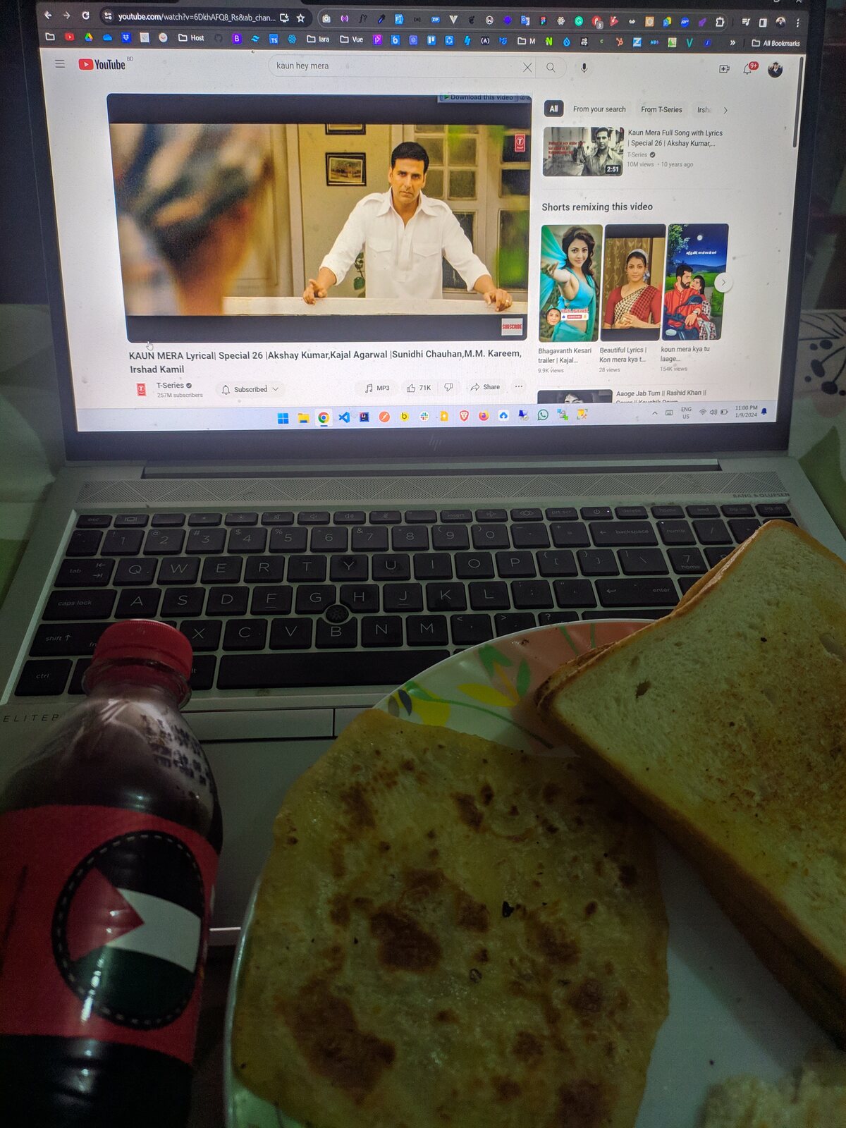 A laptop playing a coffee-roasting video with a snack bag on it.