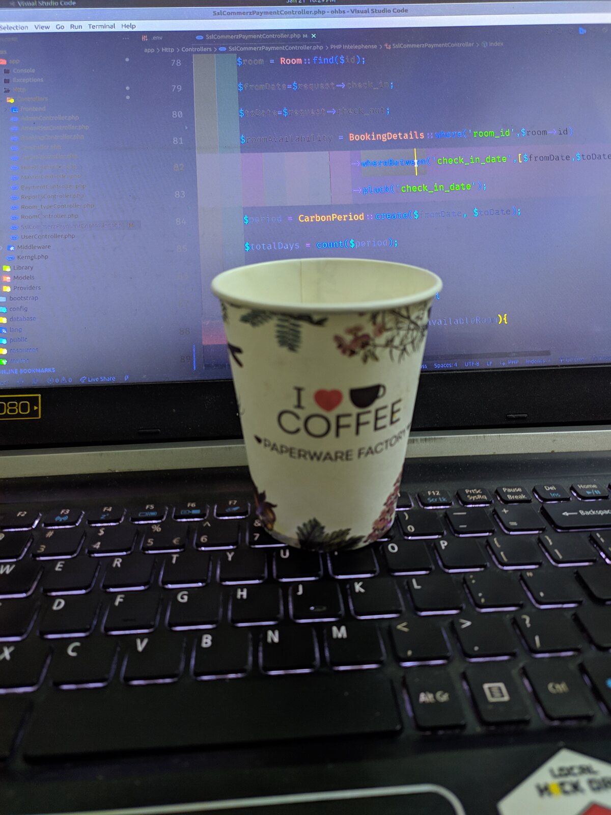 A bowl of dessert with a spoon in front of a laptop.