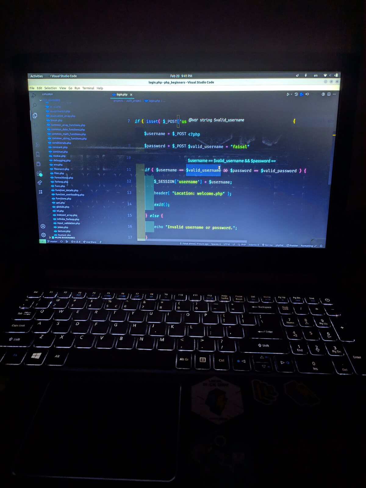 A tray of fried fish fingers beside a laptop showing code.
