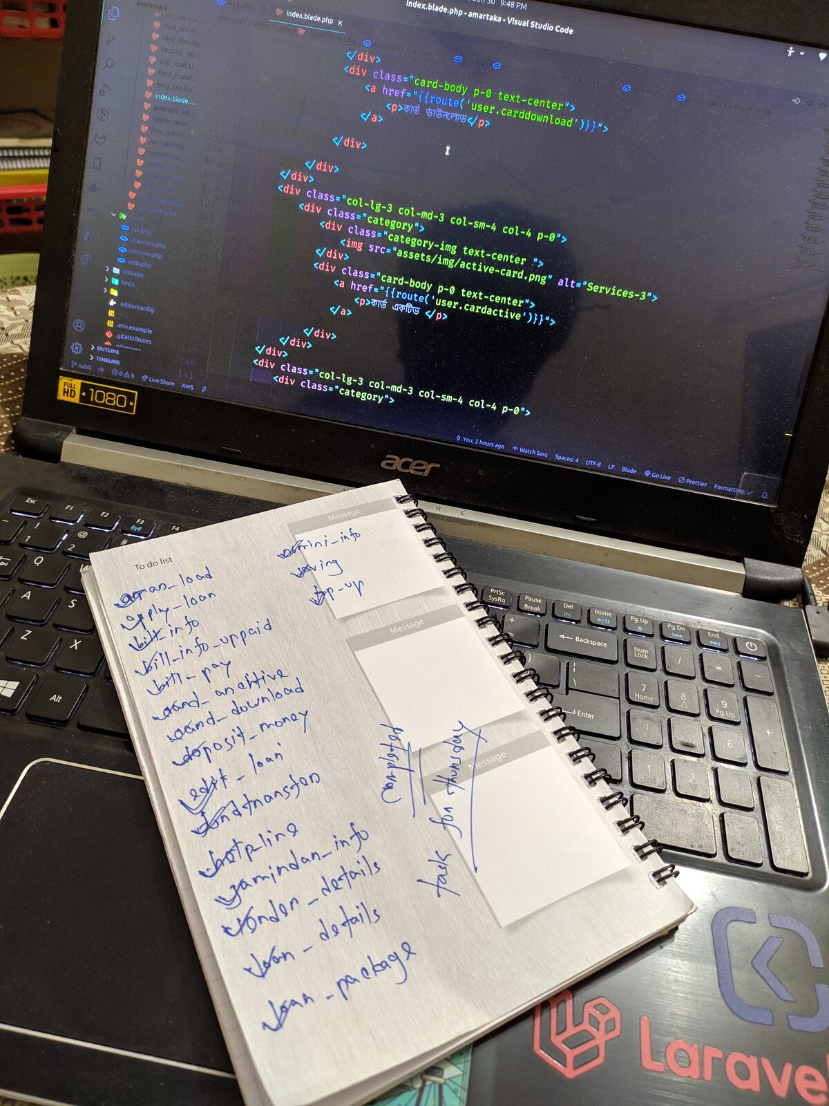 A laptop showing a 'Git Coders' themed wallpaper.