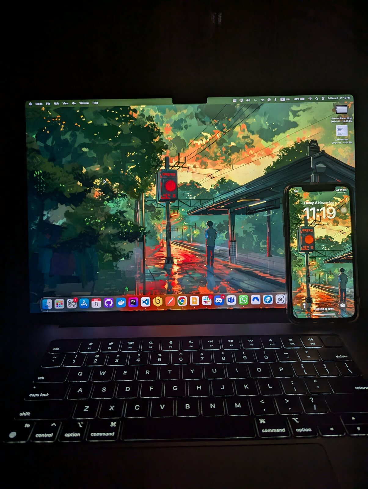 A MacBook with a forest wallpaper and a loaded dock at night.