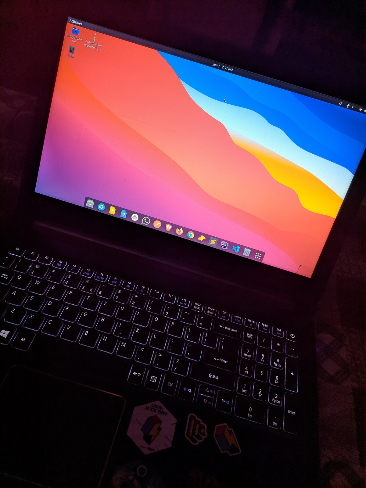 An open notebook next to a laptop showing code at an office.