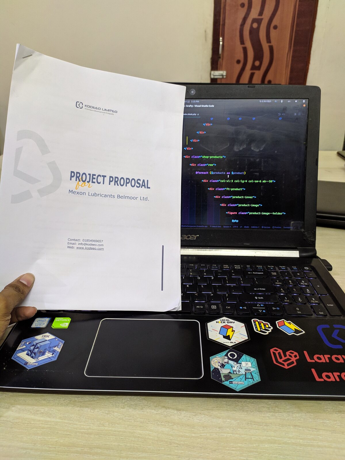 A small notebook with notes resting on a laptop keyboard.