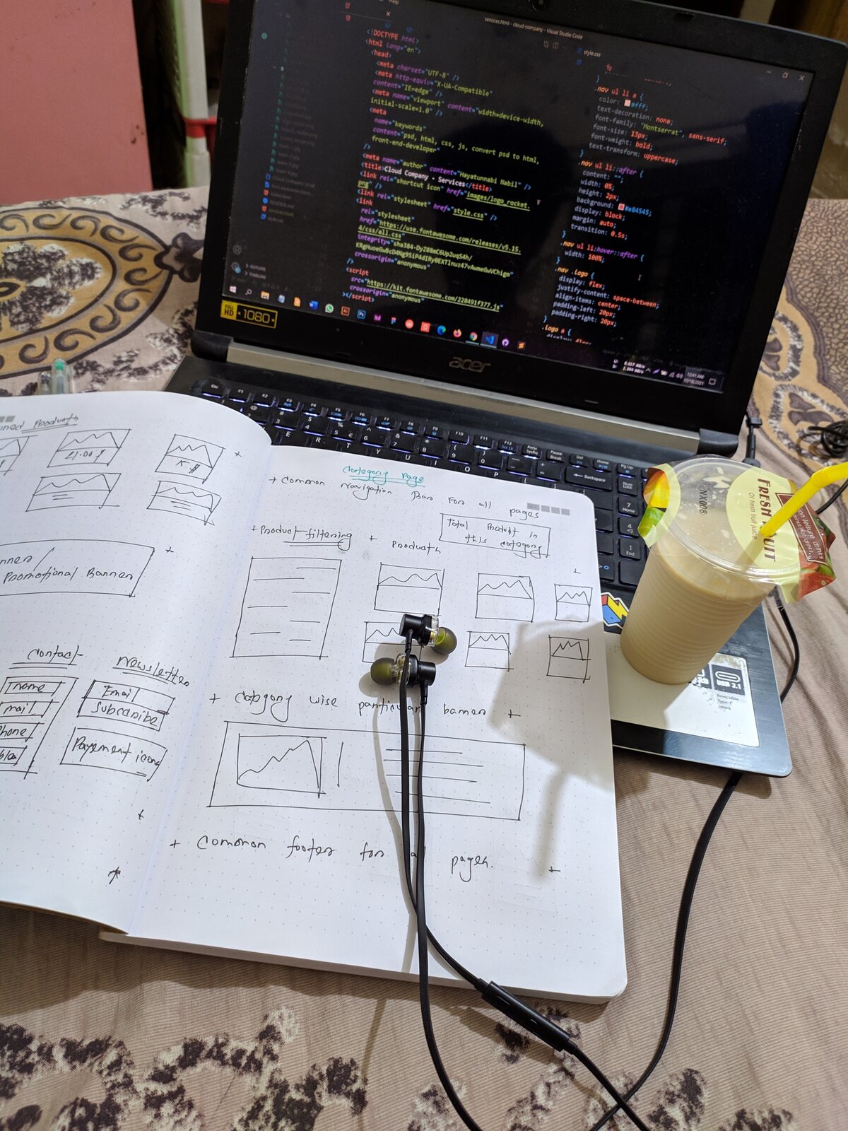 A handwritten notebook resting on a laptop keyboard.