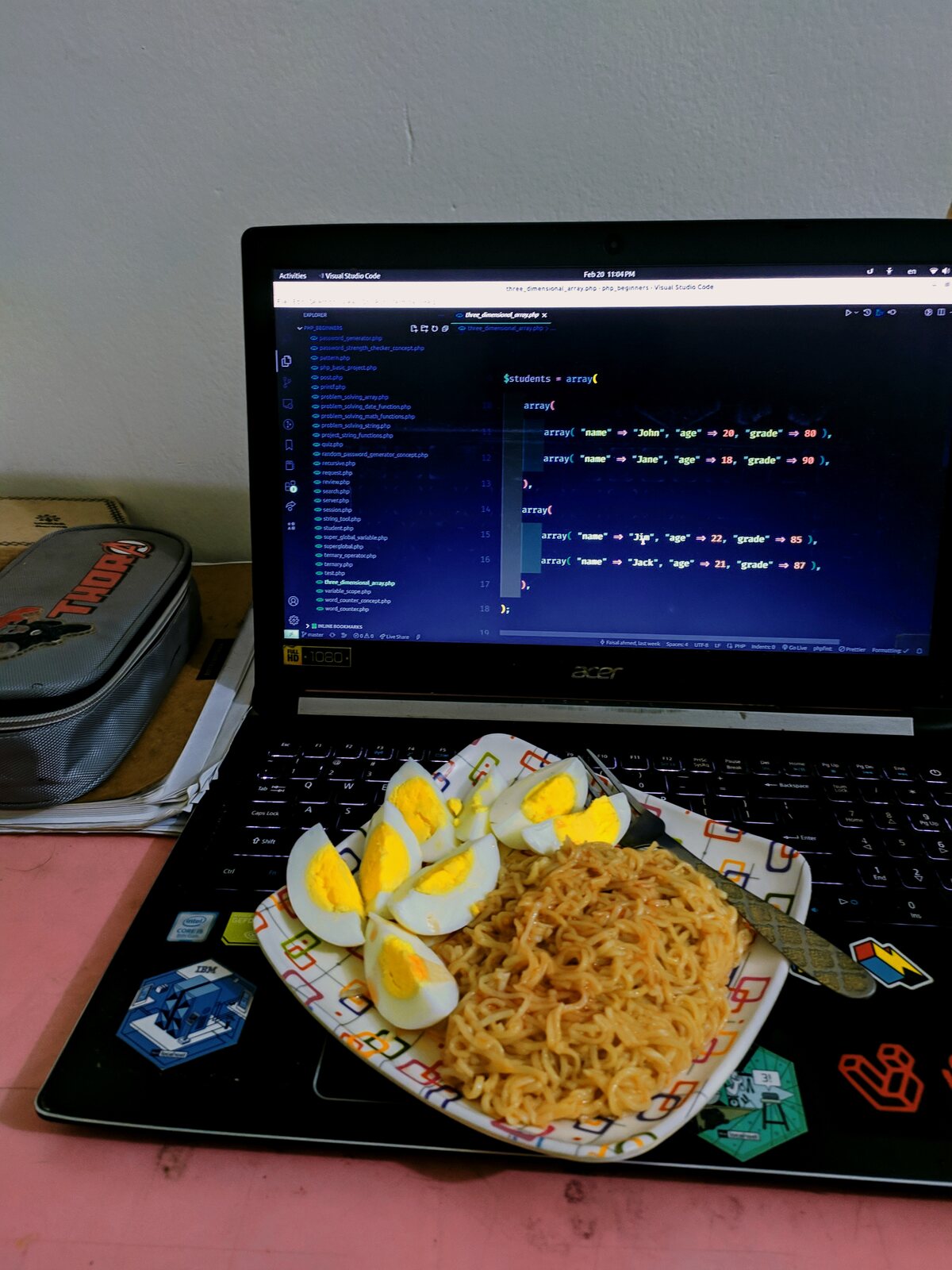 A printed project proposal document propped against a laptop.